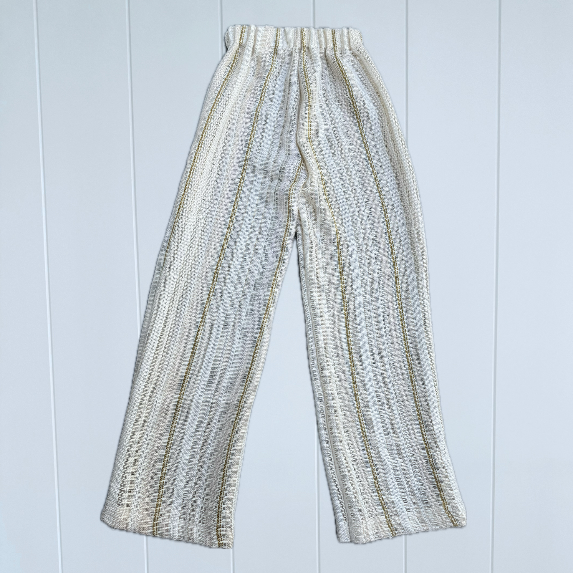 Striped pants on a light blue wooden background